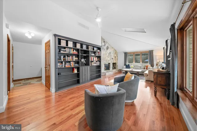 a living room with fireplace furniture and a wooden floor
