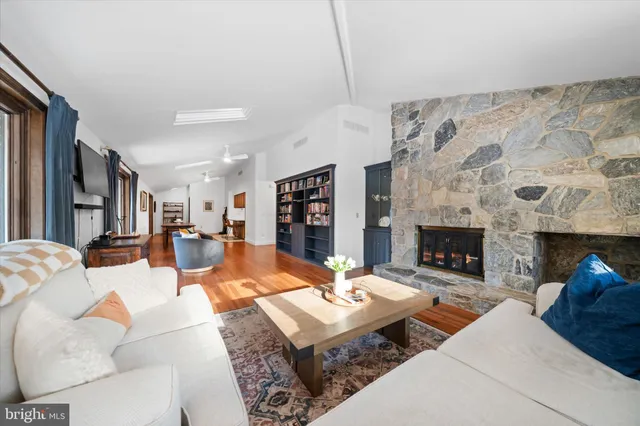 a living room with furniture and a fireplace