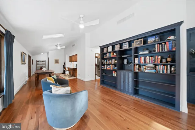 a living room with furniture and a book shelf