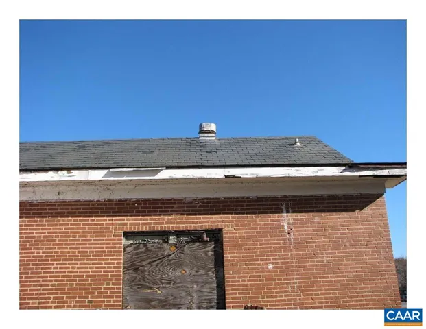 a view of a house with a yard covered in snow