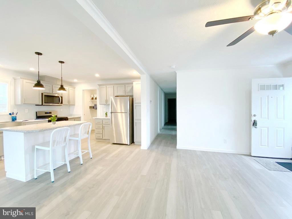 11 Folkstone Lane Lewes, DE 19958 - Photo 11 of 47 a large white kitchen with white cabinets and refrigerator