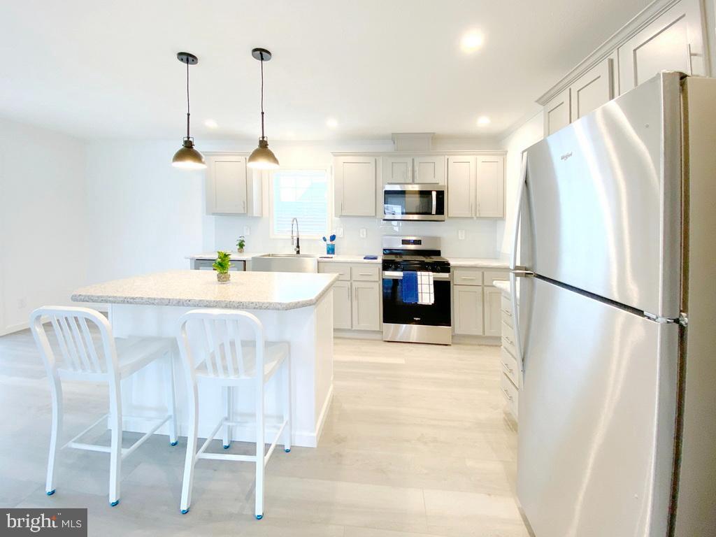 11 Folkstone Lane Lewes, DE 19958 - Photo 17 of 47 a kitchen with stainless steel appliances a refrigerator and a stove top oven