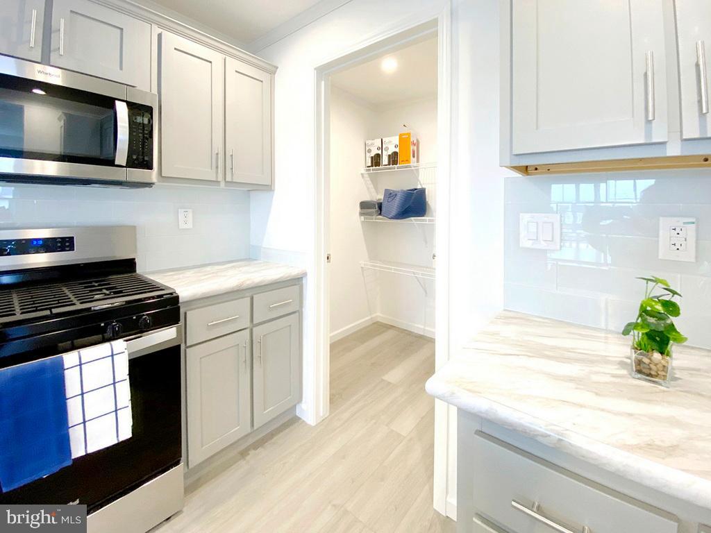 11 Folkstone Lane Lewes, DE 19958 - Photo 18 of 47 a kitchen with stainless steel appliances granite countertop a sink and a stove