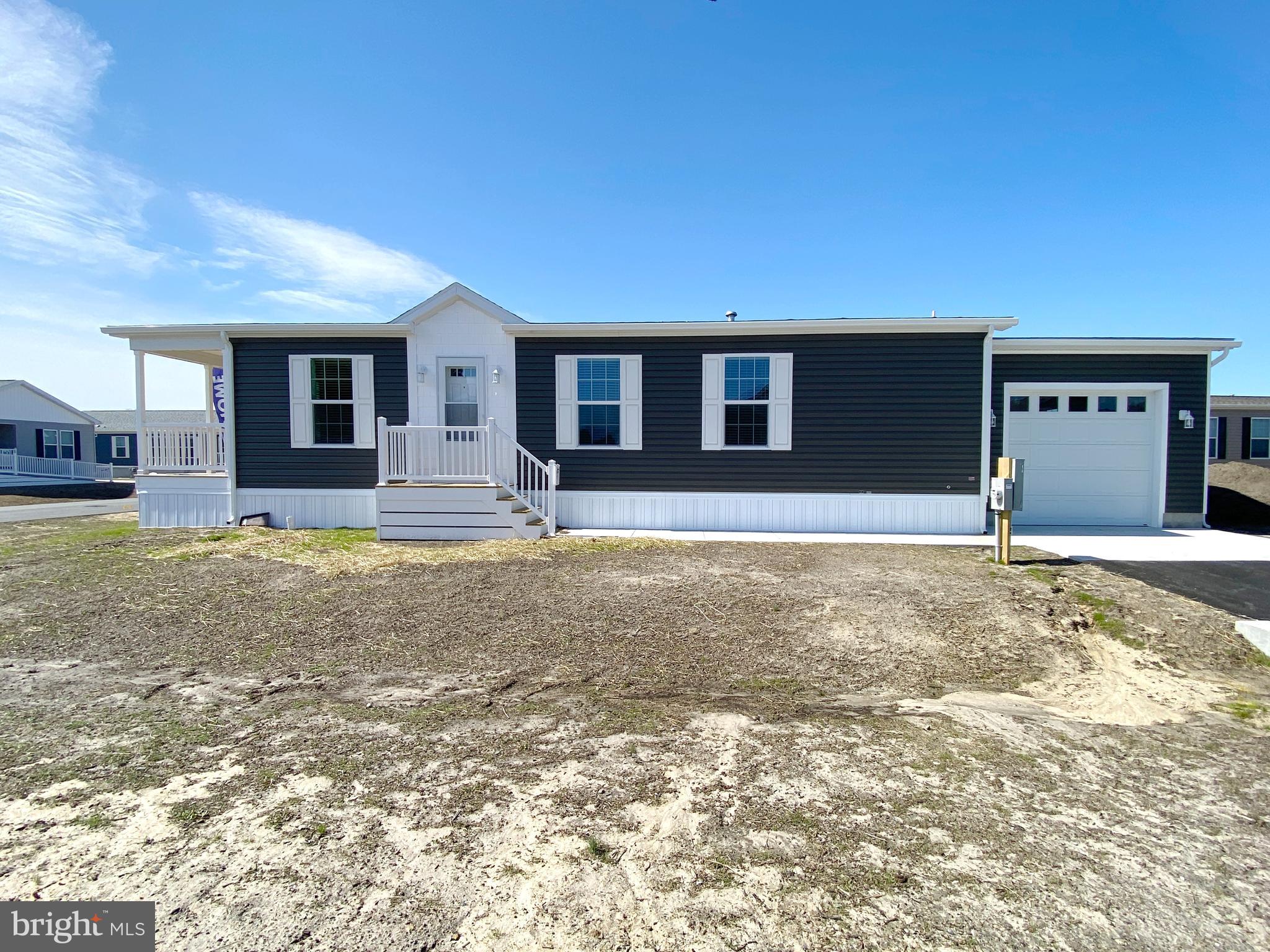 11 Folkstone Lane Lewes, DE 19958 - Photo 2 of 47 a front view of a house with yard and seating space
