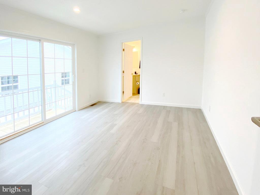11 Folkstone Lane Lewes, DE 19958 - Photo 28 of 47 wooden floor in an empty room with a window