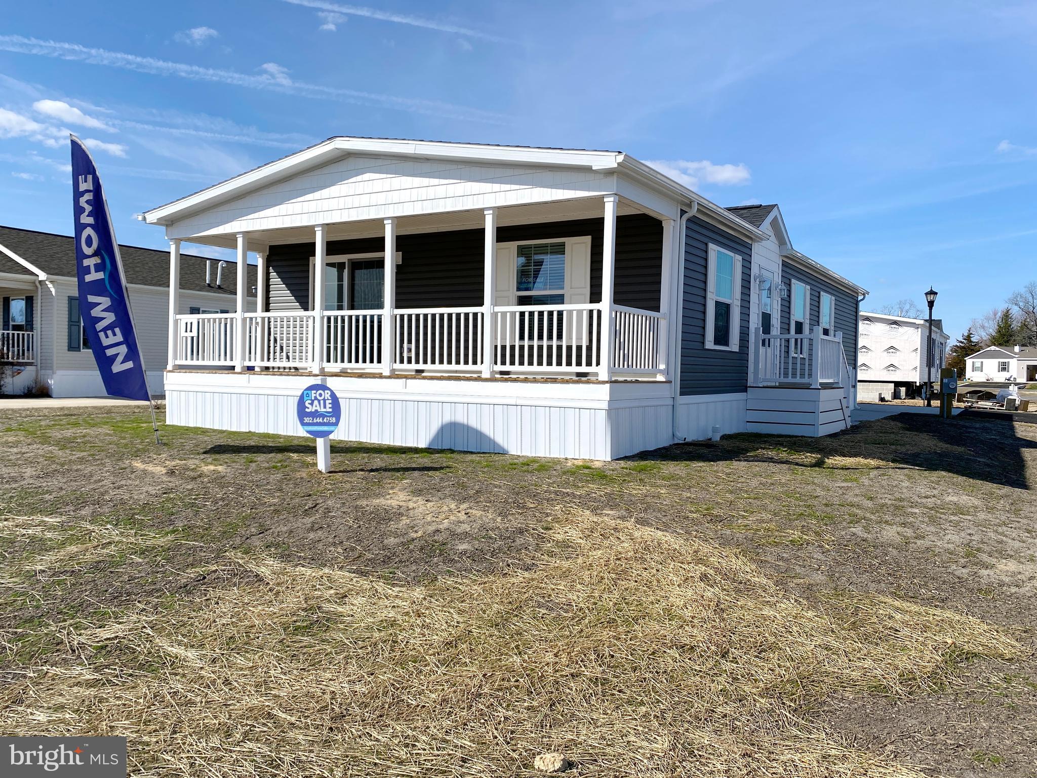 11 Folkstone Lane Lewes, DE 19958 - Photo 3 of 47 a front view of a house with a yard