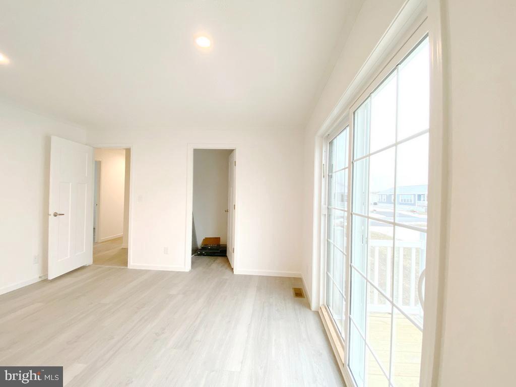11 Folkstone Lane Lewes, DE 19958 - Photo 30 of 47 a view of an empty room with wooden floor and a window