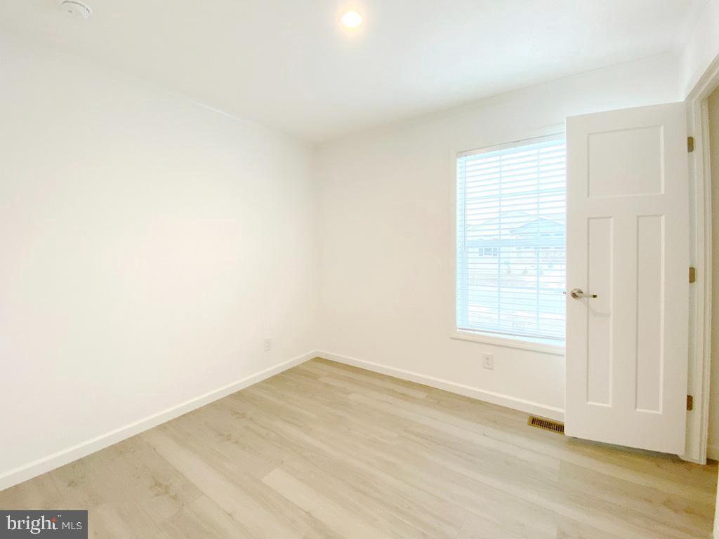 11 Folkstone Lane Lewes, DE 19958 - Photo 38 of 47 an empty room with wooden floor and windows
