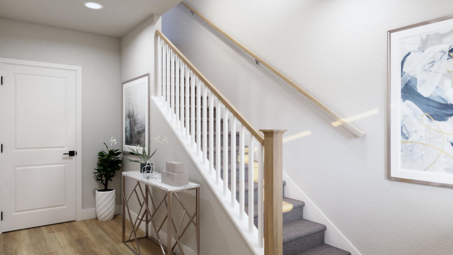 a view of hallway with wooden floor and stairs
