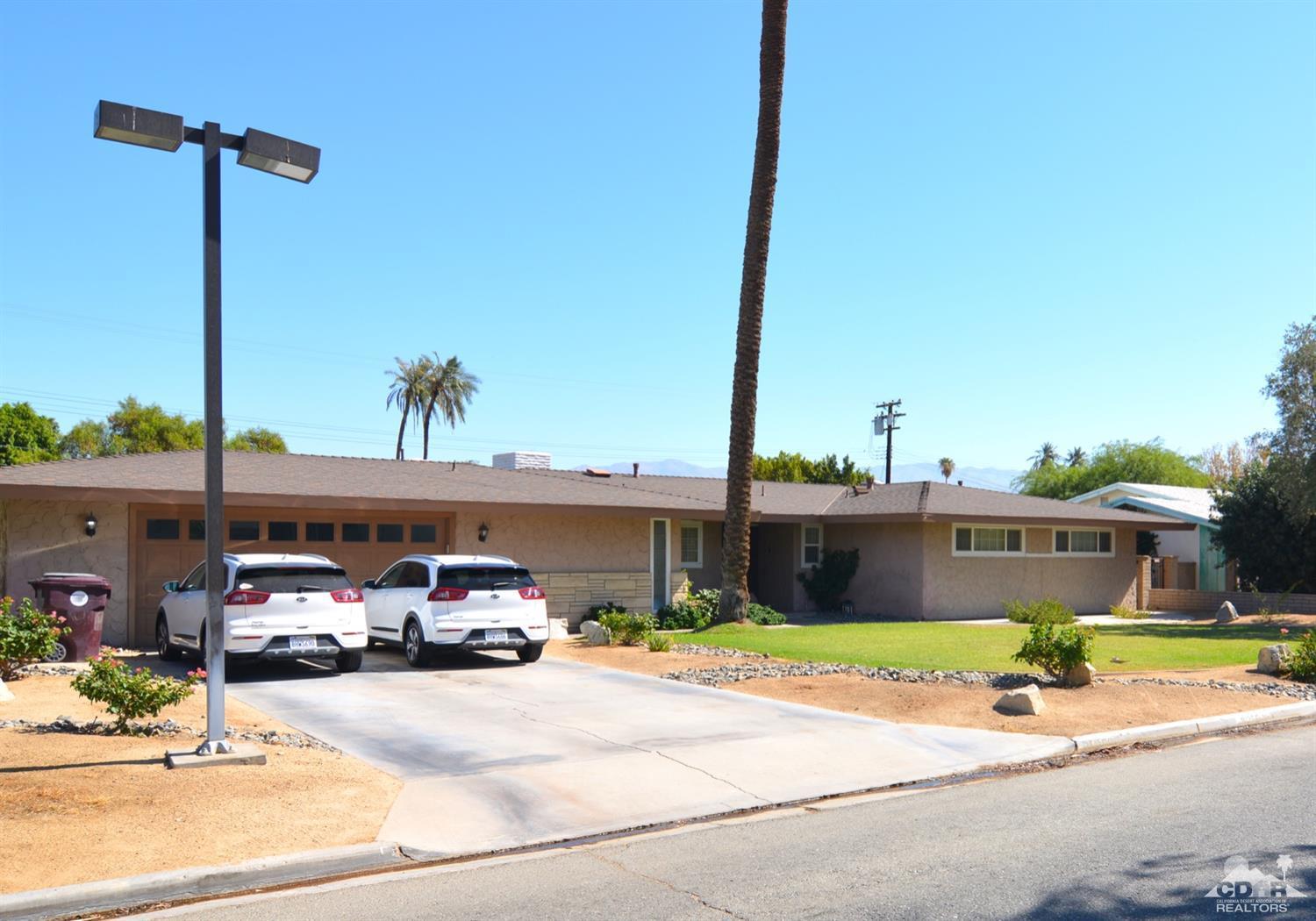 81256 Alberta Avenue Indio, CA 92201 - Photo 1 of 18 a front view of a house with a yard and balcony