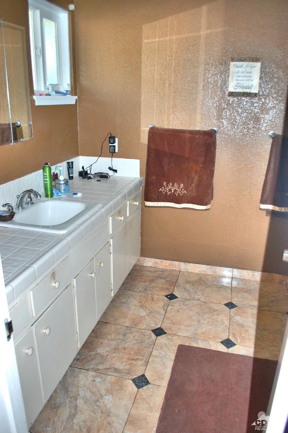 81256 Alberta Avenue Indio, CA 92201 - Photo 12 of 18 a bathroom with a sink and a mirror