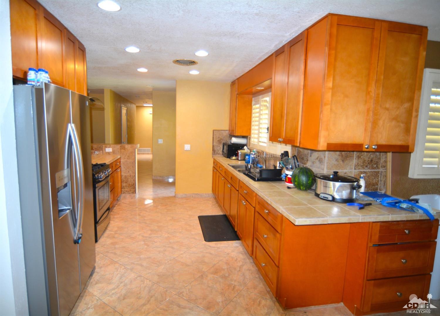 81256 Alberta Avenue Indio, CA 92201 - Photo 6 of 18 a kitchen with stainless steel appliances a sink a counter top space and a window