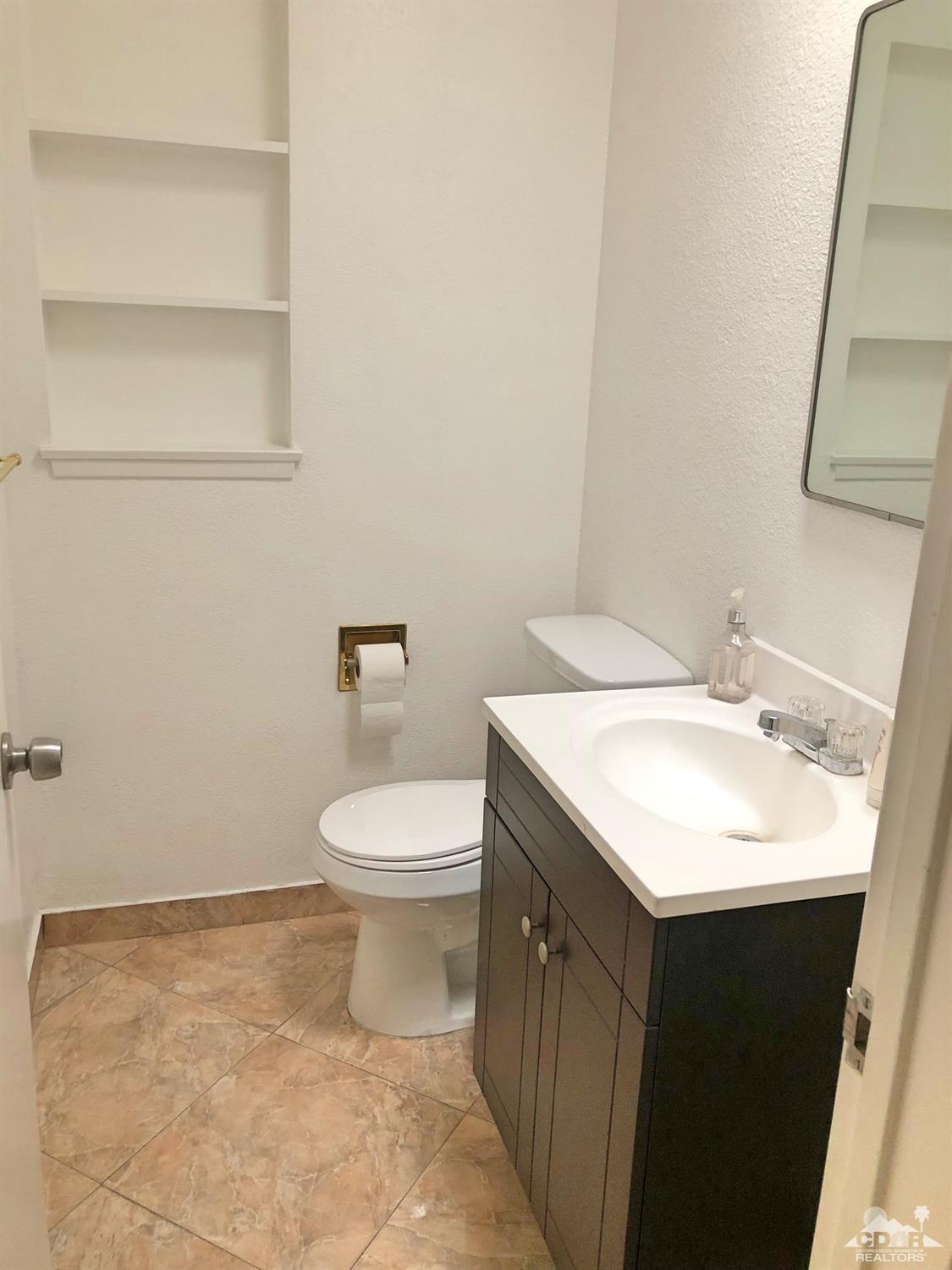 81256 Alberta Avenue Indio, CA 92201 - Photo 9 of 18 a bathroom with a sink a toilet and mirror