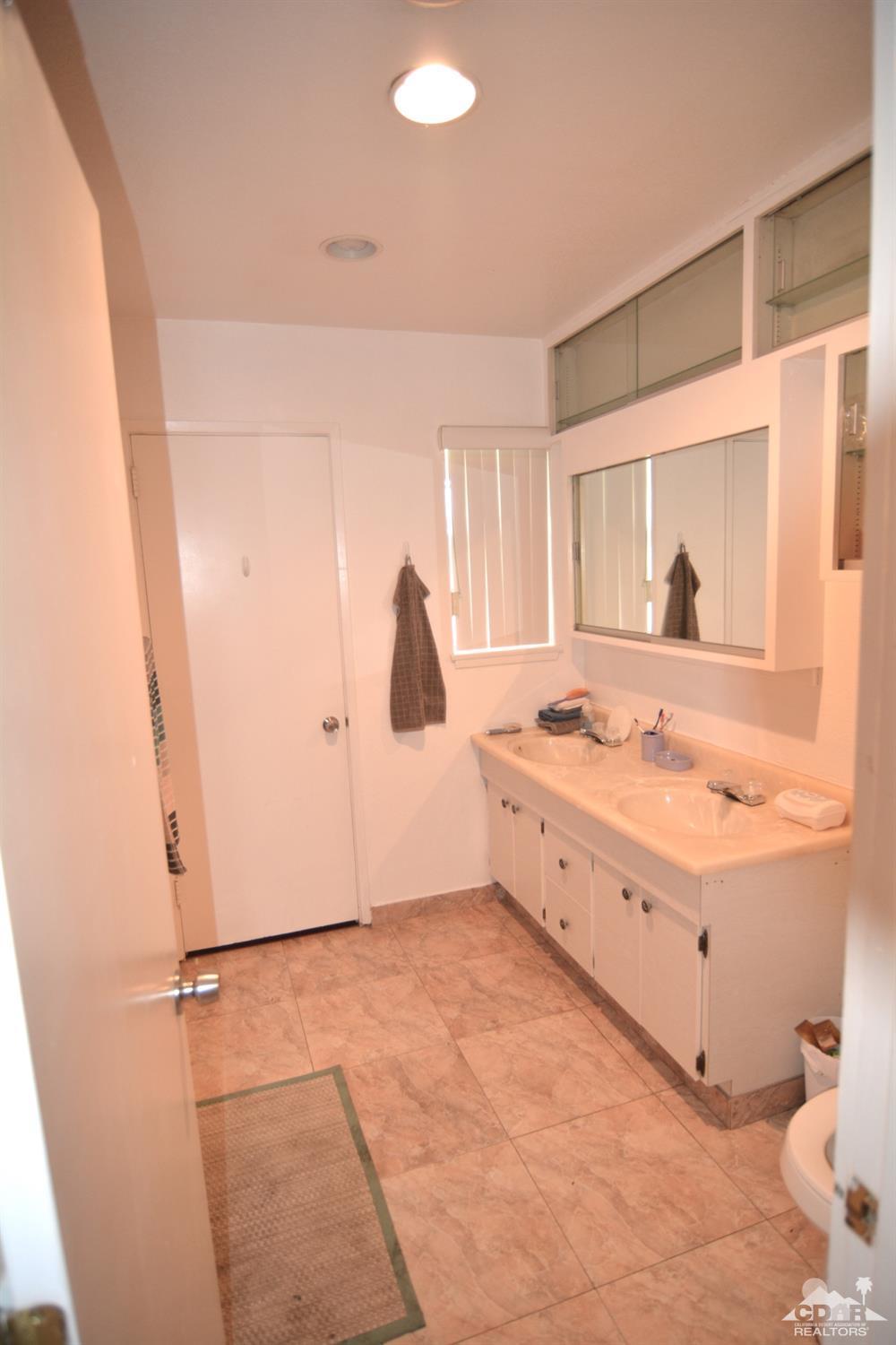 81256 Alberta Avenue Indio, CA 92201 - Photo 10 of 18 a large bathroom with a tub a sink and a window