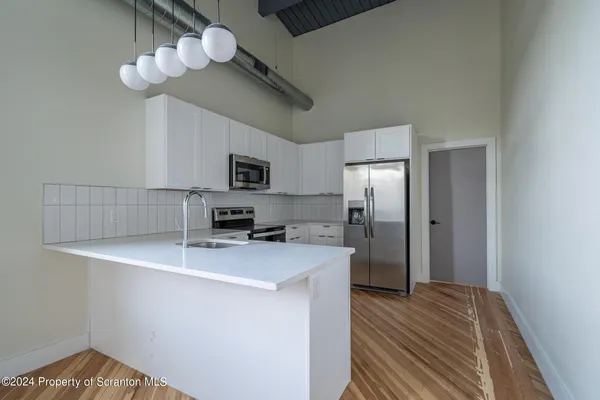 a view of a room with wooden floor