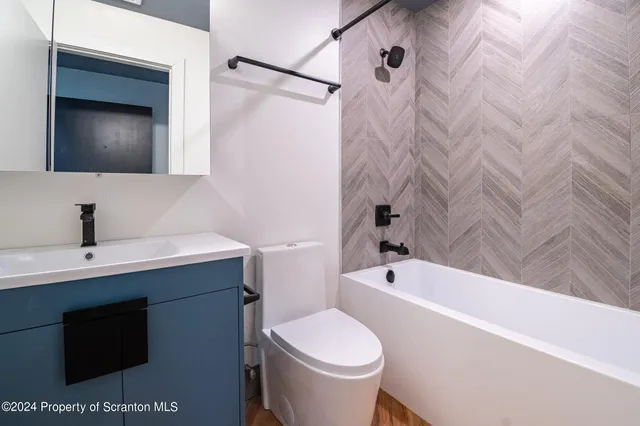a kitchen with a sink a microwave and cabinets