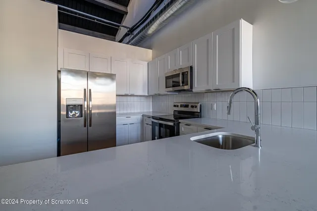 a bathroom with a sink a toilet and a bathtub