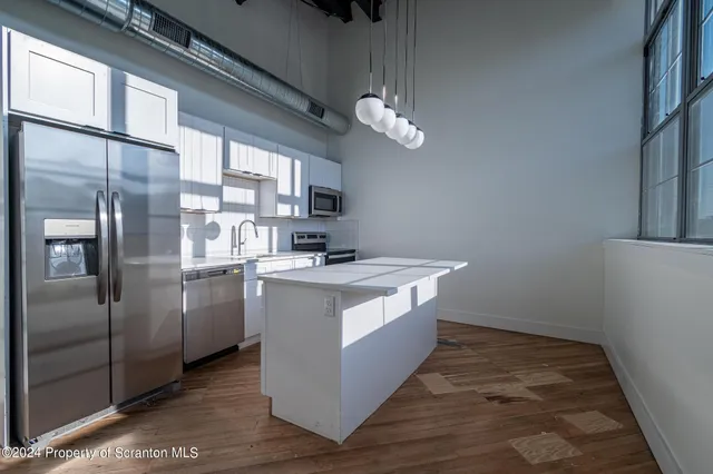 a kitchen with stainless steel appliances granite countertop a stove and a sink