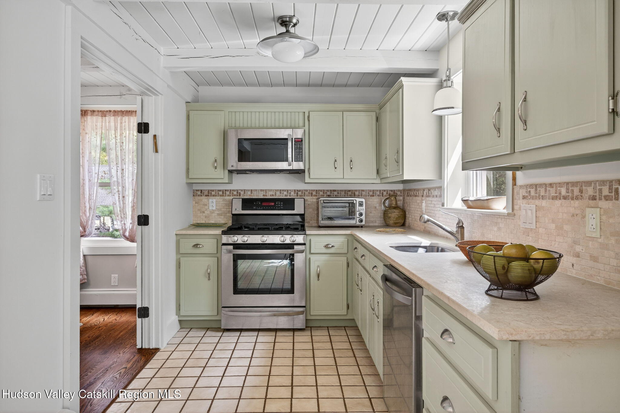 197-199 Chestnut Hill Road Stone Ridge, NY 12484 - Photo 43 of 63 a kitchen with stainless steel appliances a stove sink and cabinets
