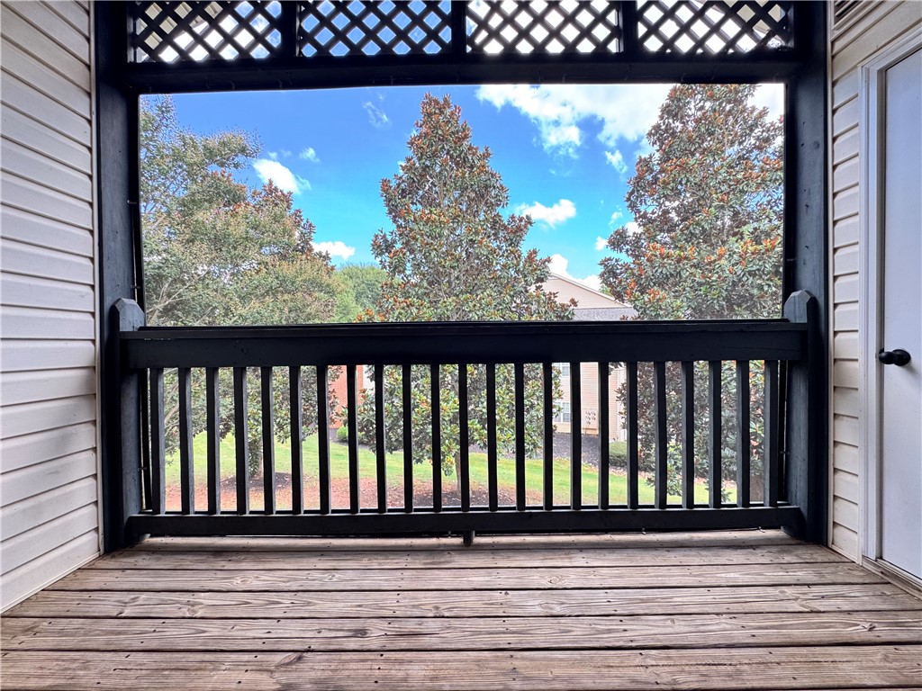 160 Wexford Drive, Unit 206 Anderson, SC 29621 - Photo 31 of 31 A quaint porch with natural wood flooring provides a serene space for outdoor enjoyment.