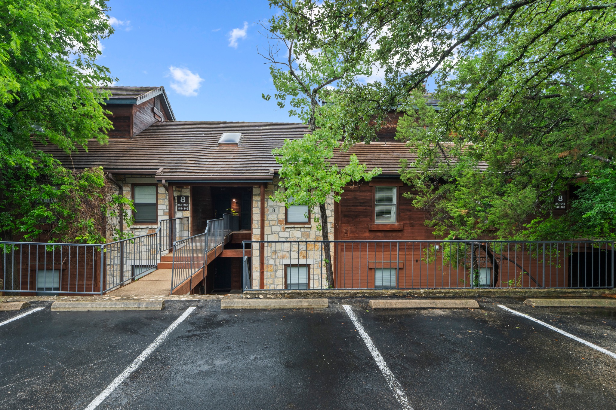 4711 Spicewood Springs Road, Unit 8146 Austin, TX 78759 - Photo 5 of 17 Multi-level building exterior featuring stone and wood siding