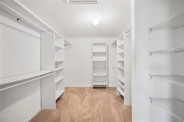 a view of walk in closet with empty racks