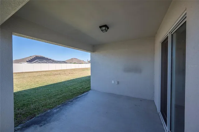 a view of an empty room and a window