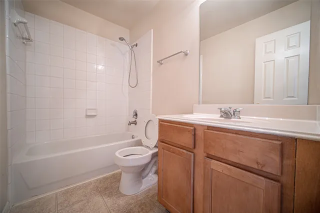 a bathroom with a sink toilet vanity and shower