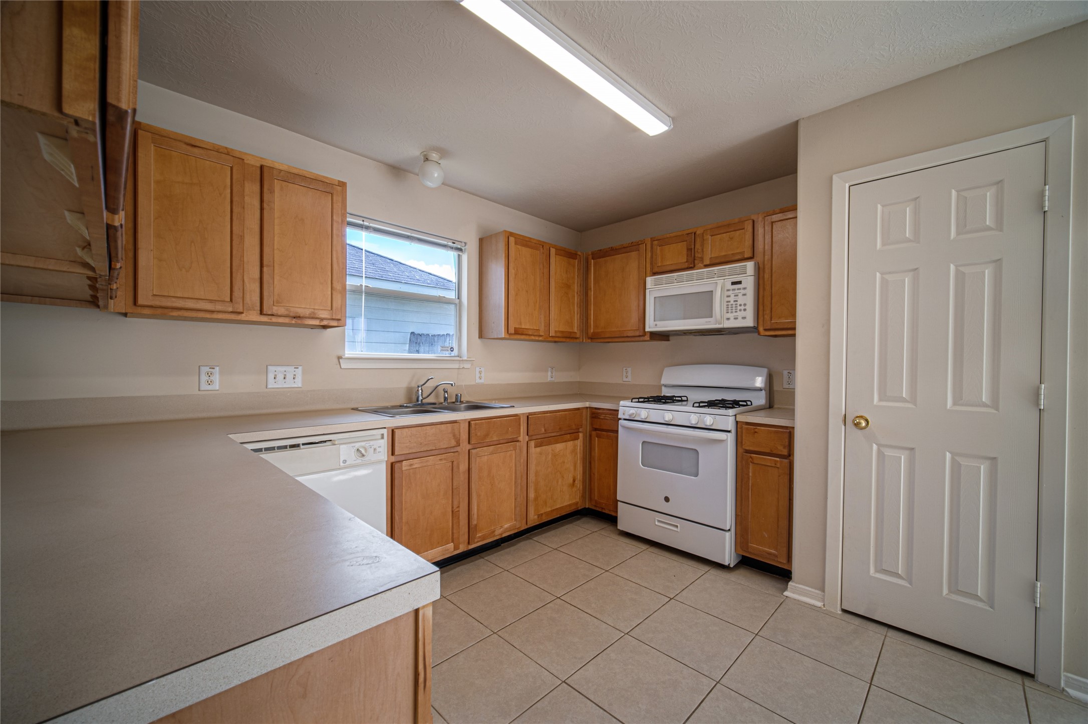 19815 Portlick Court Katy, TX 77449 - Photo 8 of 16 a kitchen with a stove top oven sink and cabinets