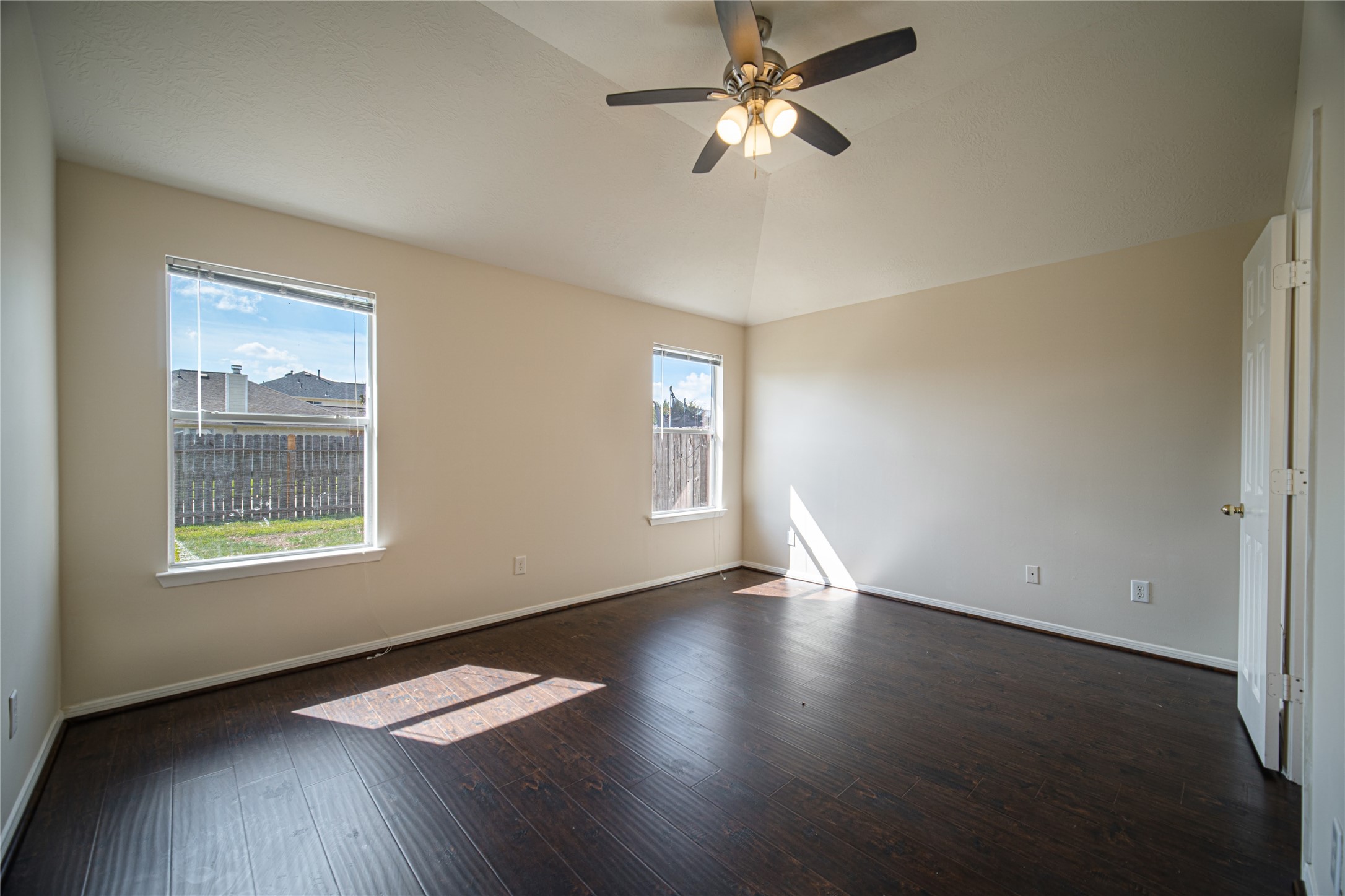 19815 Portlick Court Katy, TX 77449 - Photo 9 of 16 a view of an empty room with wooden floor and a window