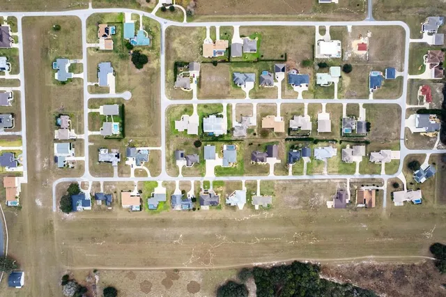 an aerial view of residential houses with outdoor space