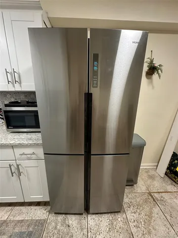 a bedroom with bed and wooden floor