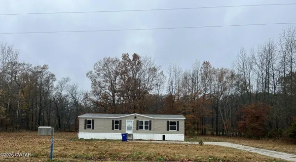 a house with trees in the background