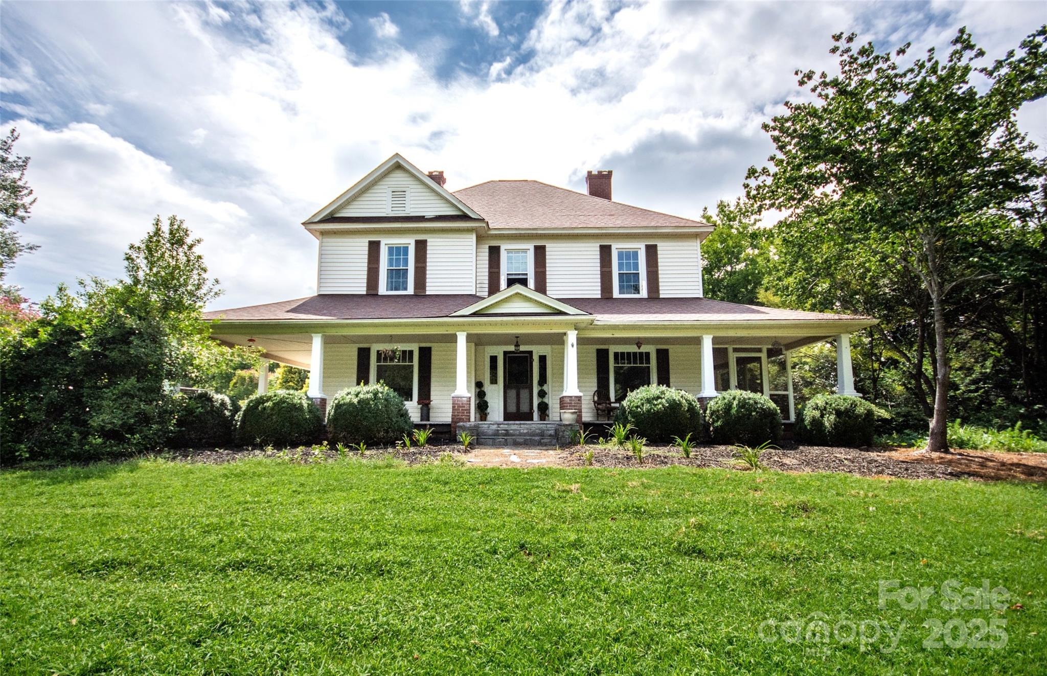 10245 Cool Springs Road Cleveland, NC 27013 - Photo 1 of 48 a front view of a house with garden and porch