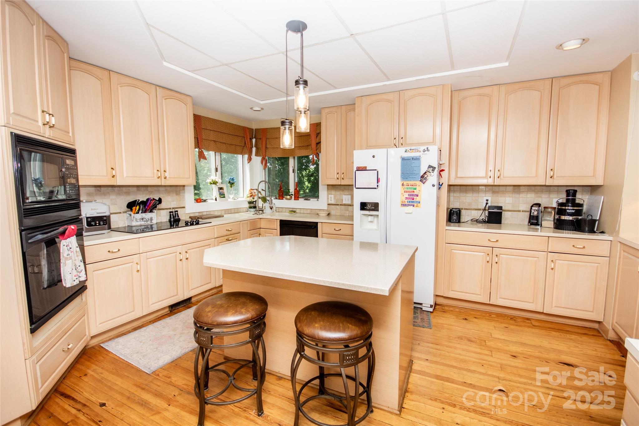 10245 Cool Springs Road Cleveland, NC 27013 - Photo 13 of 48 a kitchen with stainless steel appliances a stove a sink dishwasher a refrigerator with a dining table and chairs