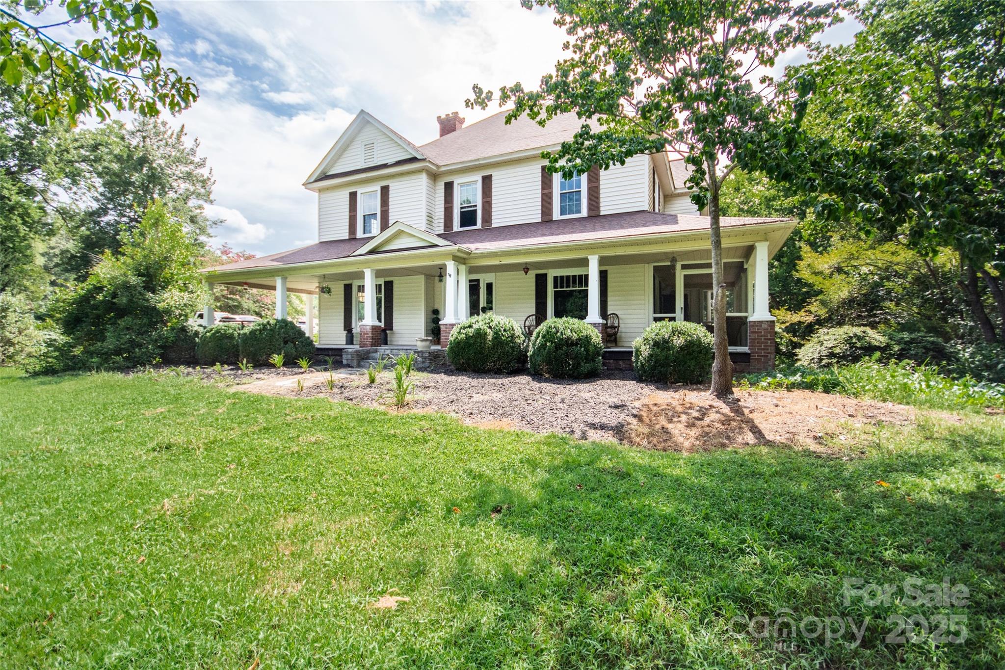 10245 Cool Springs Road Cleveland, NC 27013 - Photo 2 of 48 a front view of a house with a yard and potted plants