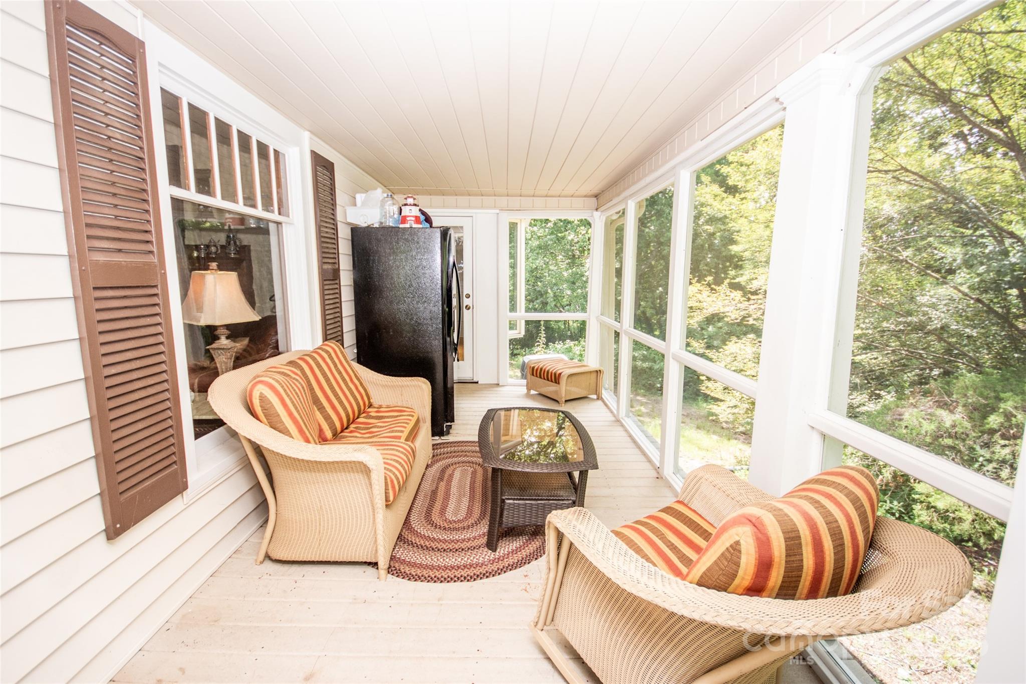 10245 Cool Springs Road Cleveland, NC 27013 - Photo 31 of 48 a living room with furniture and a floor to ceiling window