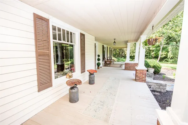 a view of a house with a barbeque and wooden stairs