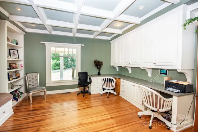 a work space with wooden floor and furniture