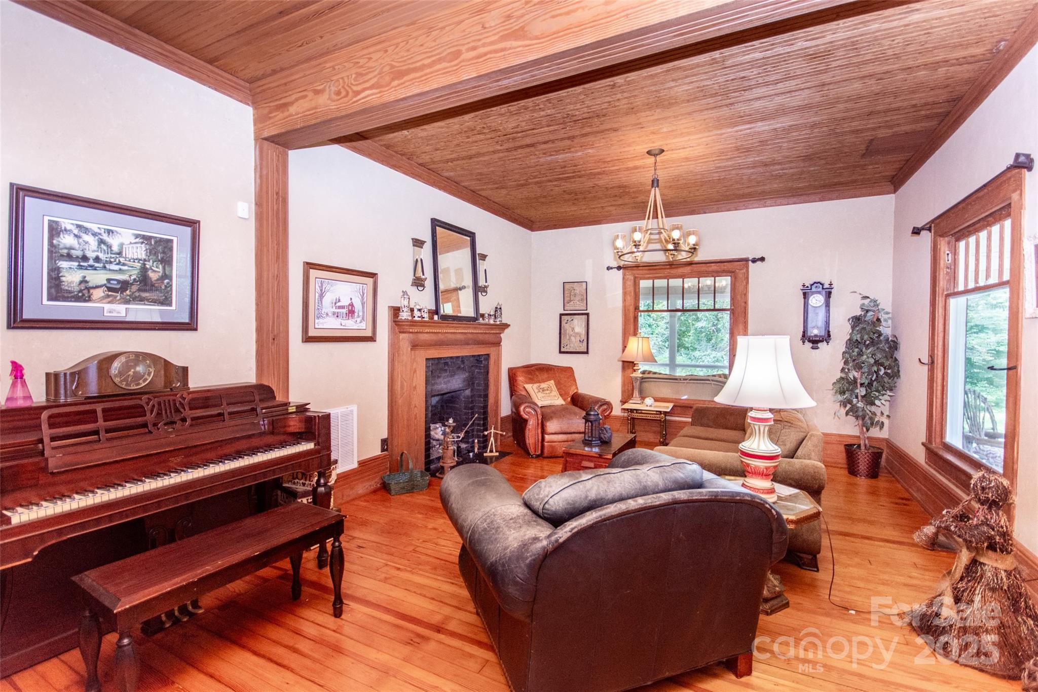 10245 Cool Springs Road Cleveland, NC 27013 - Photo 5 of 48 a living room with furniture a fireplace and a chandelier
