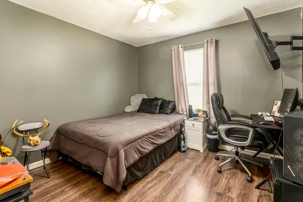 a bedroom with a bed and a chandelier