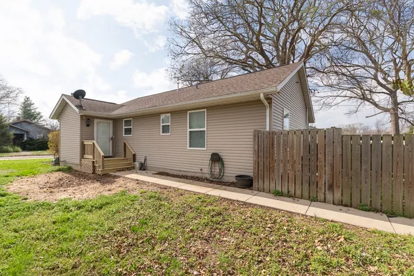 a view of a house with backyard and sitting area