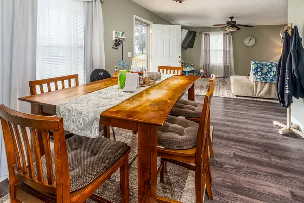 a dining room with furniture and wooden floor