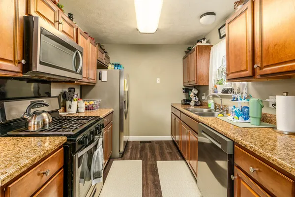 a kitchen with stainless steel appliances granite countertop a stove and a sink