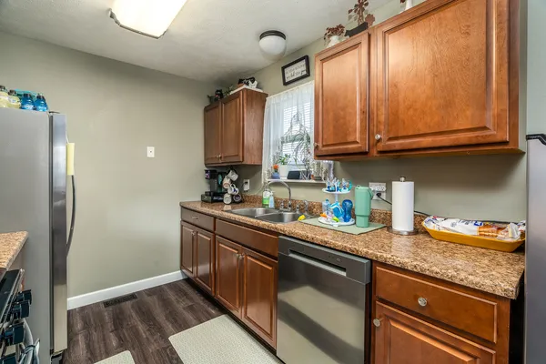 a kitchen with stainless steel appliances granite countertop a sink stove and refrigerator