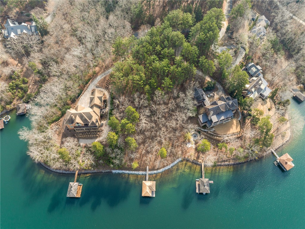 113 Deep Cove Court Sunset, SC 29685 - Photo 6 of 9 This aerial view showcases a picturesque waterfront property with multiple residences and private docks.