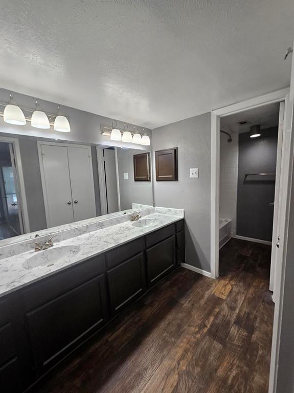 a spacious bathroom with a double vanity sink and mirror