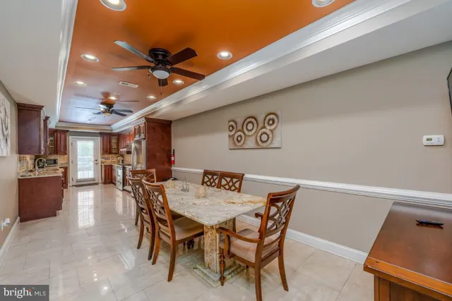 a dining room with furniture and a ceiling fan