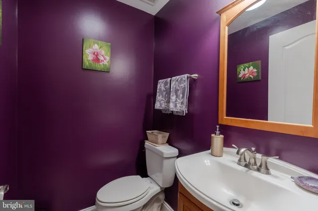 a bathroom with a sink a toilet and mirror