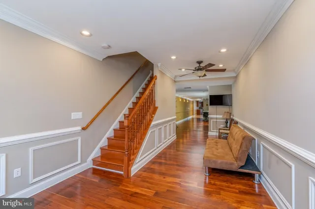 a view of entryway and hall with wooden floor
